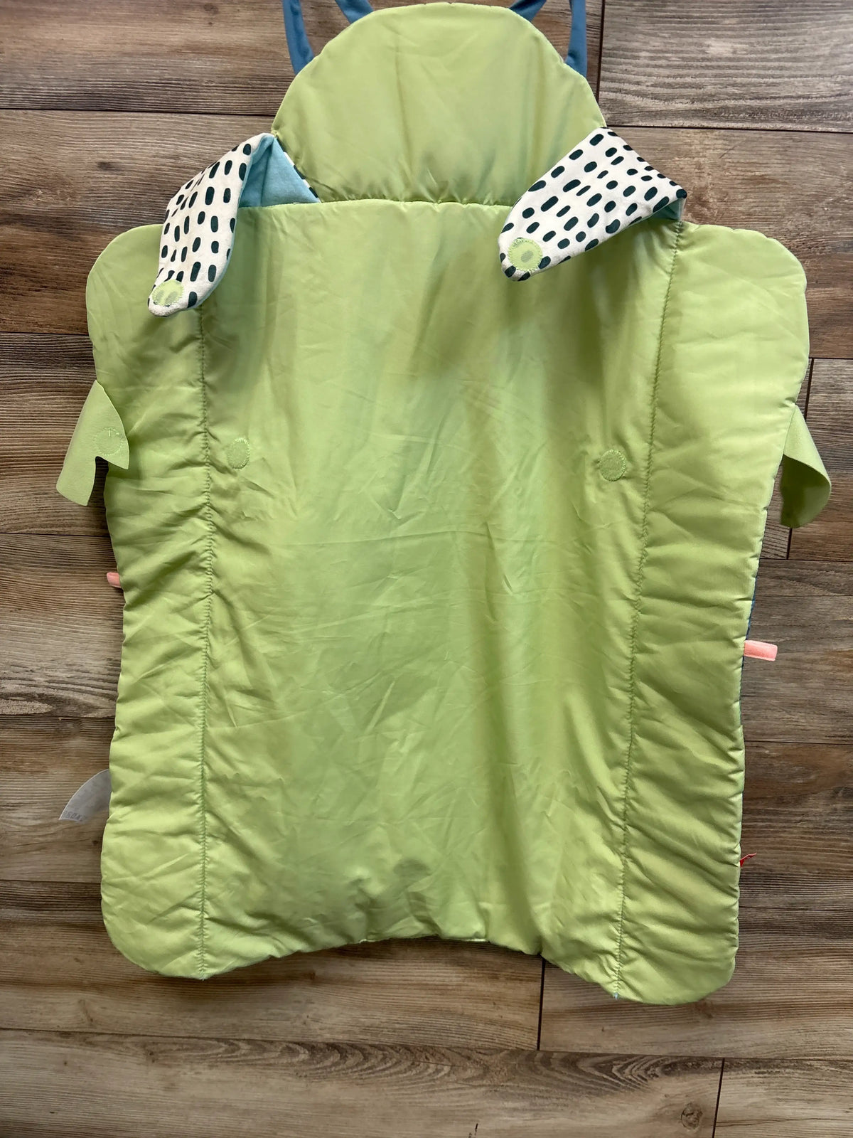 Top view of Fisher-Price Roly-Poly Panda Play Mat with lime green padding and patterned ears on wood flooring