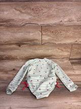 Flat lay of Cat and Jack girls' long-sleeve striped rash guard with strawberry print and side ties on wood background