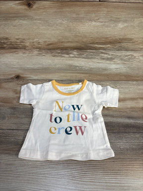 Baby t-shirt with 'New to the crew' text in pastel colors on wood background