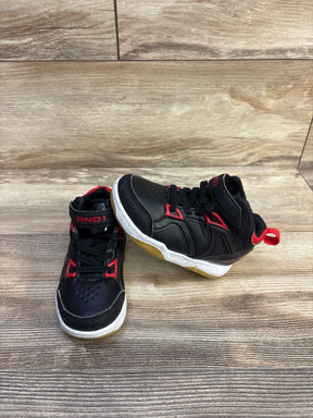 Front three quarter view of black AND1 high-top basketball shoes with red trim, velcro strap and gum sole on wood floor