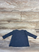 Flat-lay back view of Jumping Beans long-sleeve grey toddler shirt showing ribbed knit texture and crew neckline on light wood plank background size 12 months