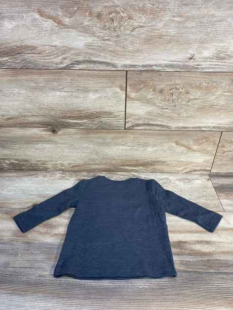 Flat-lay back view of Jumping Beans long-sleeve grey toddler shirt showing ribbed knit texture and crew neckline on light wood plank background size 12 months