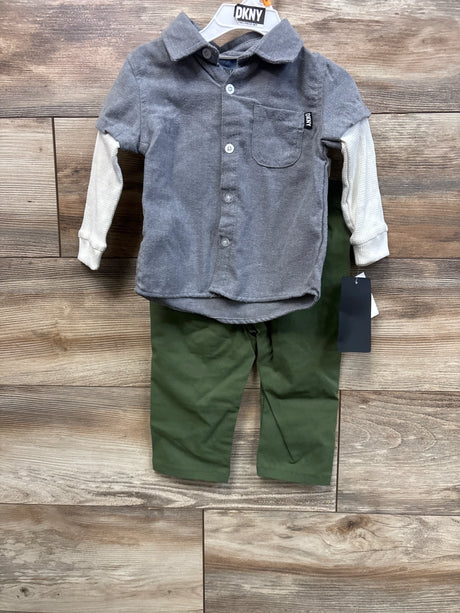 Front view of DKNY 2-piece baby set showcasing grey layered-sleeve button-up shirt and green pants on wood background