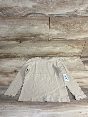 Beige long sleeve kids shirt with Old Navy tag, laid flat on wooden background