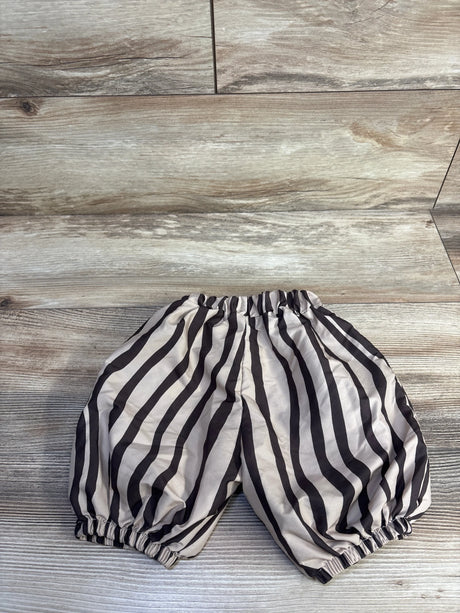 Flat lay of brown Taiaojing striped balloon baby pants size 6M with elastic waist and gathered cuffs on light wood background