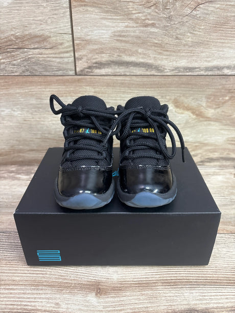 Front view of Air Jordan 11 Retro TD Gamma Blue sneakers in size 8C showcasing black uppers and translucent blue soles on a box