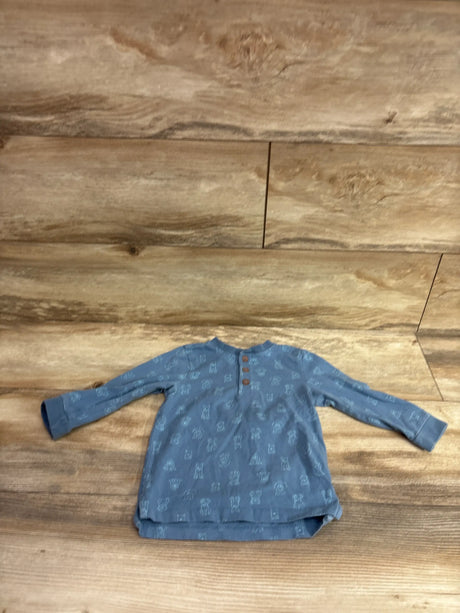 Blue Me n Mommy To Be baby henley shirt with an all-over pattern on a wooden background
