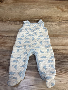 Flat lay of Minibean white footed jumpsuit with blue dinosaur print and snaps along legs on wood background