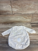 Cream baby sleeper with bunny print and fuzzy patch displayed on wood floor