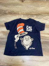 Navy blue kids t-shirt featuring The Cat in the Hat graphic with red striped hat on wood background