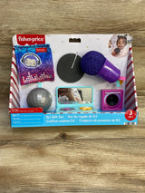 Front view of Fisher-Price DJ gift set showing purple microphone, toy turntable, mirror, and speaker on wood background
