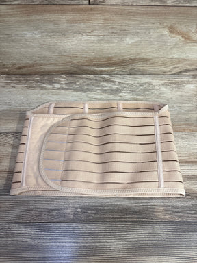 Beige elastic abdominal compression belt with Velcro strap on wood surface