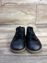 Front view of Teeny Toes Oxford baby first-walker shoes in black showing lace-up front and translucent tan sole on wood floor