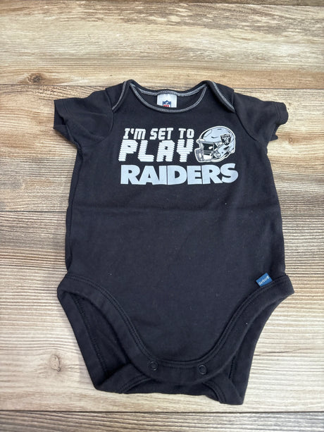 Front view of black Raiders bodysuit, size 0/3m, with I’m Set To Play graphic and snap closures on wood background
