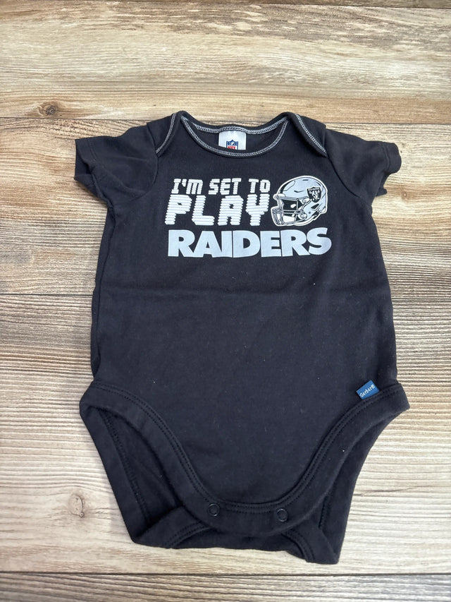 Front view of black Raiders bodysuit, size 0/3m, with I’m Set To Play graphic and snap closures on wood background