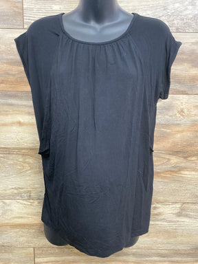 Front view of black maternity nursing shirt with scoop neck and nursing openings on mannequin over wood backdrop