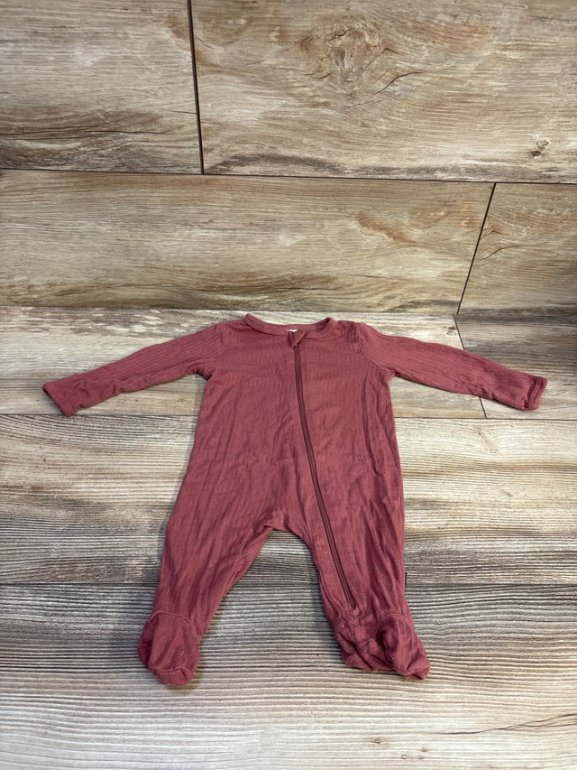 Front view of red ribbed viscose sleeper in newborn size with long sleeves, zipper, and footed legs on wood-look background