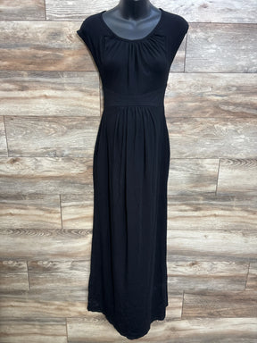 Front view of black maternity cap-sleeve maxi dress with empire waist and gathered skirt on mannequin against wood backdrop