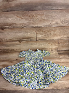 Girls' short sleeve floral dress with blue and yellow flowers on wood background