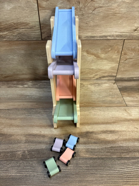 Wooden rainbow car ramp toy with four pastel mini cars on wooden floor