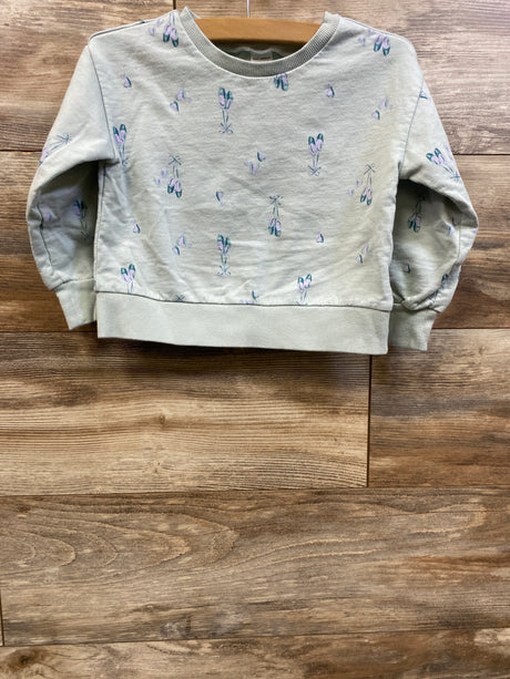Front view of Carter’s mint pullover sweatshirt in size 3T showcasing an all-over floral print on a wood background