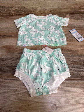 Flat lay of Cat & Jack mint two-piece baby set showing ribbed short-sleeve top and elastic-waist bunny-print shorts on wood
