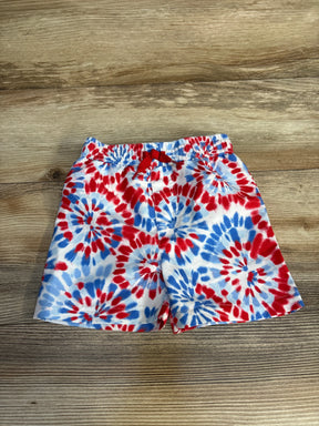 Red, white, and blue tie-dye kids swim trunks with drawstring waist on wood floor