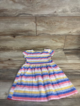 Flat-lay of Carter's girls' pink striped short-sleeve dress with gathered waist on wood floor