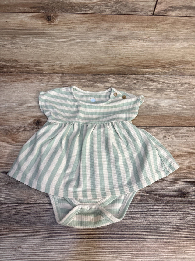 Mint green and white striped baby dress with ruffled sleeves and snap closures on wood floor