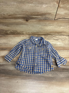 Blue and beige checkered long-sleeve button-up shirt for toddler laid on wooden floor