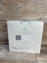 Front view of Cloud Island muslin blanket set box showing black triangle print sample and felt frame on wood floor