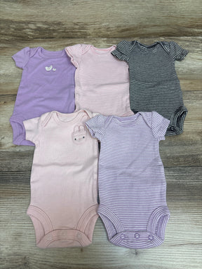 Top-down view of Carter’s five preemie bodysuits showcasing purple, pink, and striped designs on a wood surface