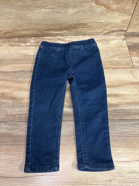 Front view of blue Pekkle jeggings in size 2T showcasing elastic waistband and front pockets with a wood-grain background