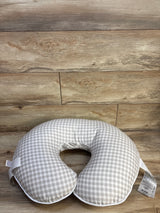 Top view of Boppy nursing pillow showing gray gingham slipcover and elephant-print inner lining on wood plank background
