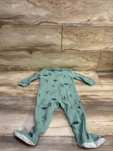 Front view of Just One You green blanket sleeper in size 12m showcasing dinosaur print and covered feet on wood background