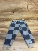 Gray and black checkered kids jogger pants with ribbed cuffs on wooden floor