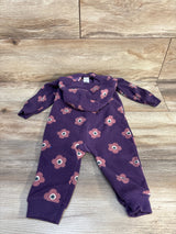 Purple floral baby romper with hood, long sleeves, and pink flower print on wood background