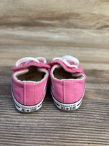 Rear view of pink Converse Cribster shoes showing CONVERSE ALL STAR heel logo and Velcro straps on wood floor