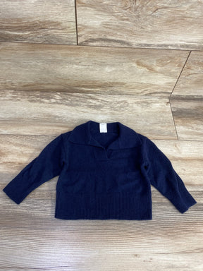 Navy blue long sleeve toddler sweater with collar, laid flat on wooden floor