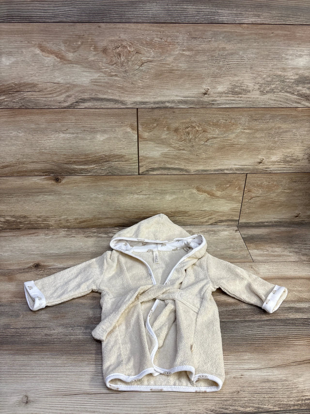 Flat lay of newborn pale yellow hooded terry cloth bath robe showing tied waist belt and white trim on wood plank background