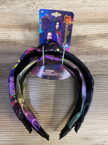 Disney Descendants 3 girls' headbands with purple, gold, and black colors on wooden surface