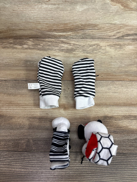 Top-down view of Infinno high-contrast baby wrist rattles and foot finders with black-and-white striped mittens on wood