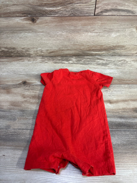 Flat lay back view of Nike shortie romper showcasing short sleeves and short legs on light wood background