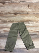 Back view of green toddler pull-on pants 3T showcasing elastic waistband and gathered ankle cuffs on wood floor