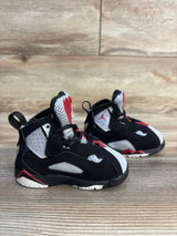 Black, white, and red toddler athletic shoes on wooden floor, gently used condition
