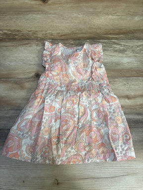 Floral print baby dress with ruffled sleeves in peach and pink on wood background