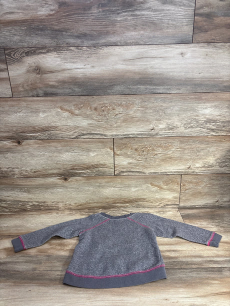 Kids long sleeve gray sweatshirt with pink stitching on wood floor background