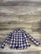 Boys long sleeve orange and blue plaid button-up shirt on wood background