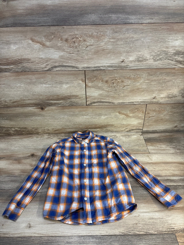 Boys long sleeve orange and blue plaid button-up shirt on wood background