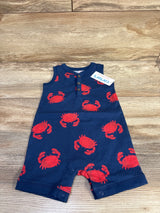 Top-down view of navy Henley shortie romper showcasing red crab print, henley buttons and snap crotch on wood background
